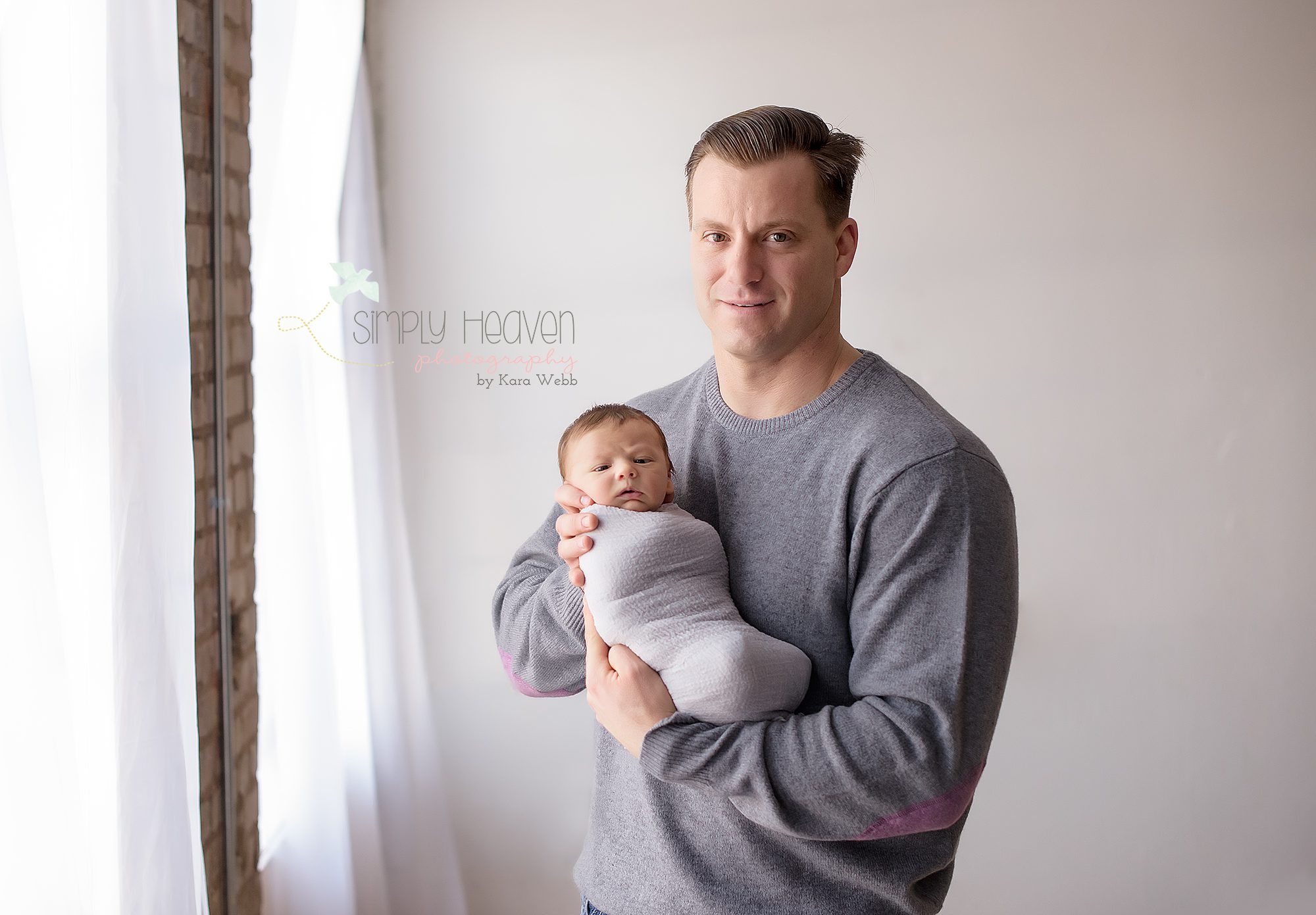 dad holding his newborn son