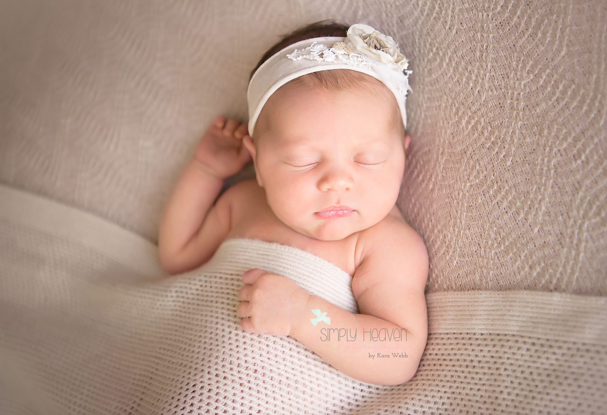 newborn baby girl in a cream headband