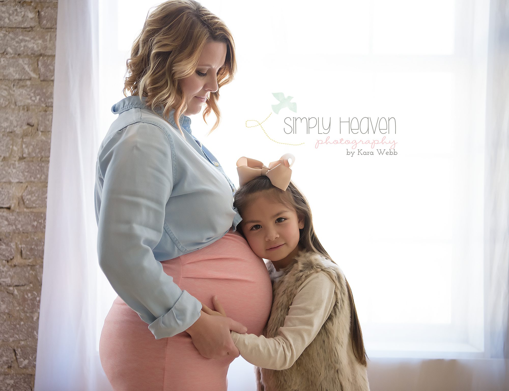 sister holding moms belly during pregnancy pictures