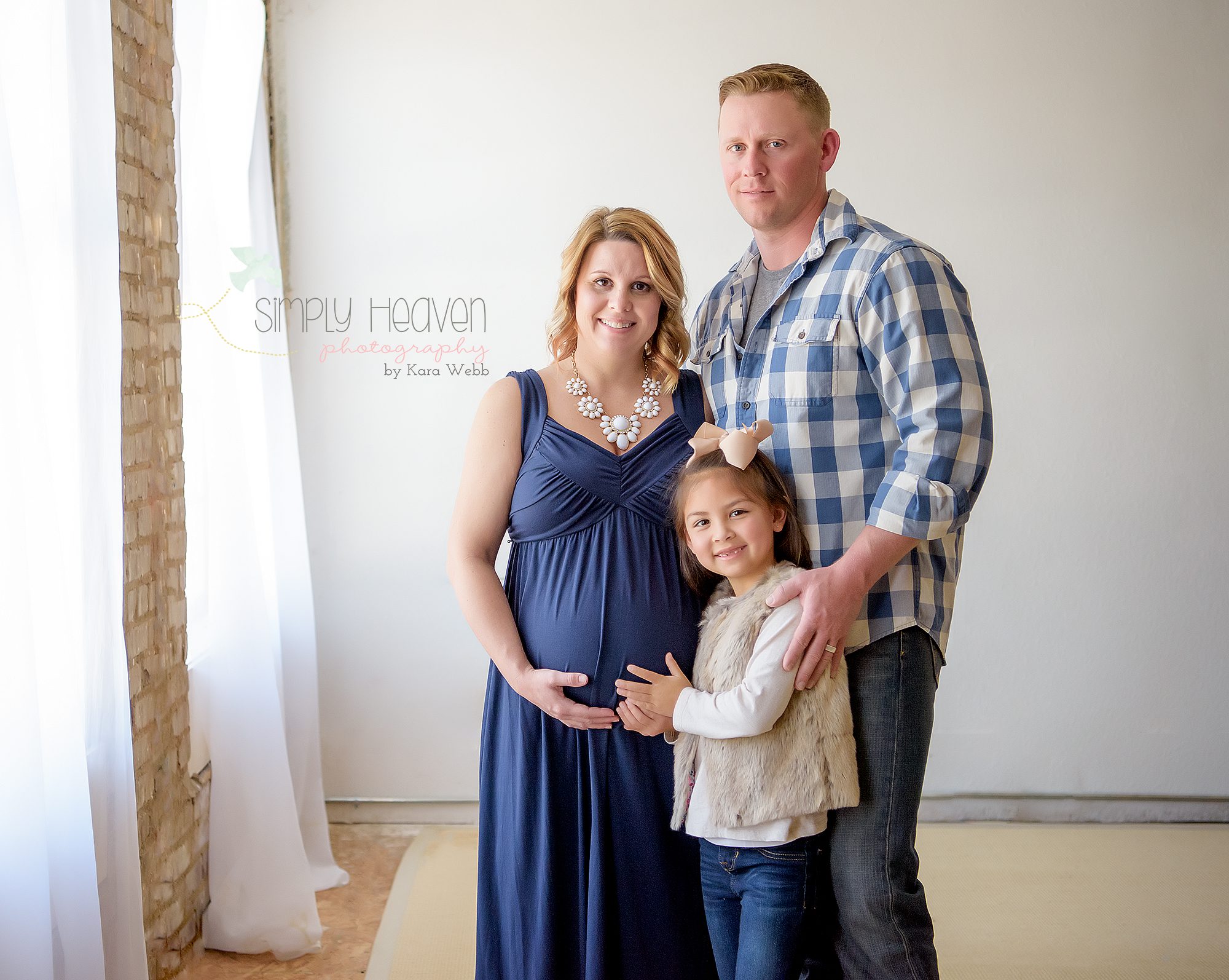 family dressed in shades of blue during maternity session