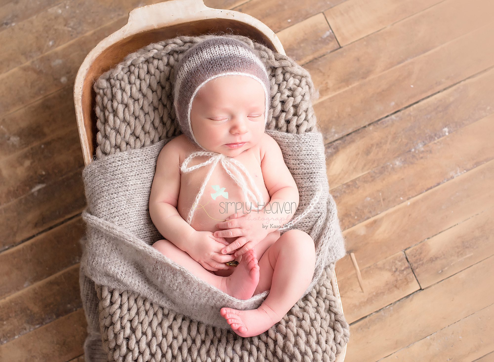 newborn baby boy in a basket on the floor