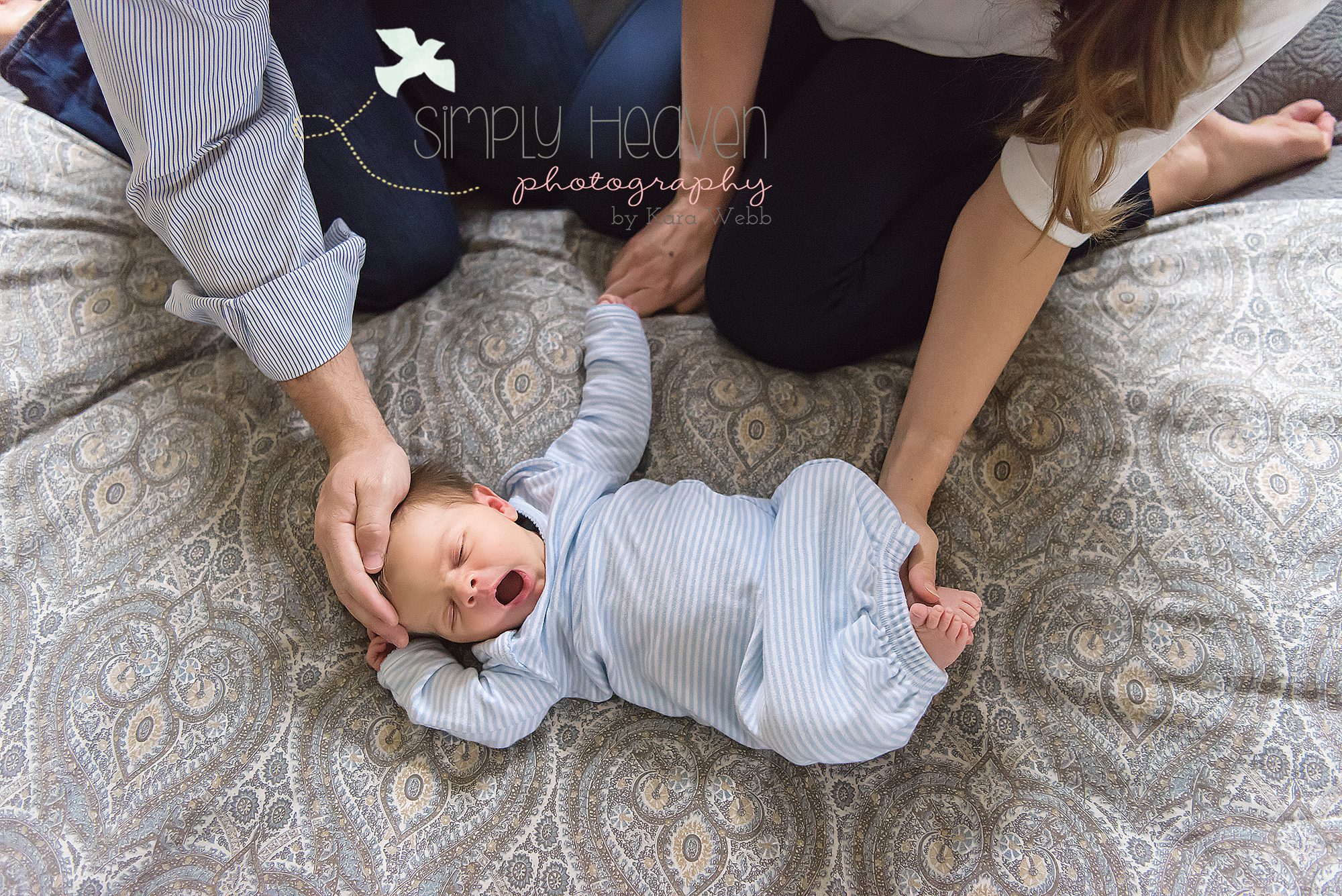 mom and dad holding newborn baby boy during an inhome newborn baby session