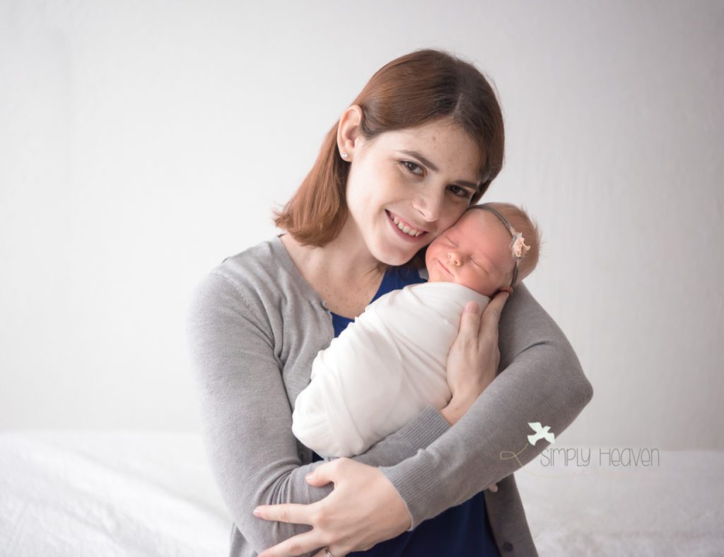 smiling baby girl being held by her mom