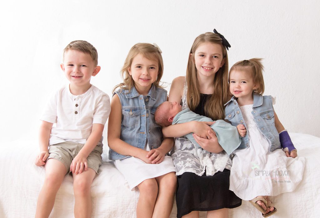 siblings with a newborn brother